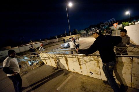 After the 6 p.m. curfew: Roadblocks and patrols set up by citizens in collaboration with the armed forces in every neighborhood of Tunis. Here in the working-class neighborhoods of Megrine Chaker in the southern suburbs of Tunis