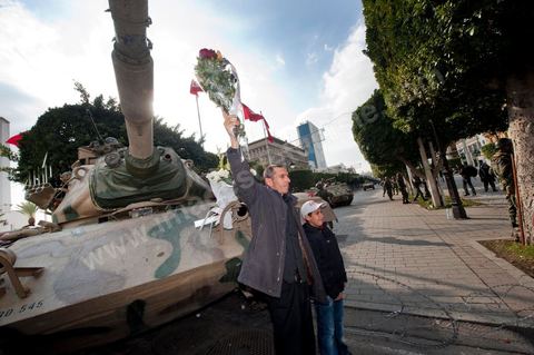January 19, 2011; a scene of the people gathered with the Tunisian army around tanks on Habib Bourguiba Avenue in Tunis