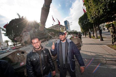 January 19, 2011; a scene of the people gathered with the Tunisian army around tanks on Habib Bourguiba Avenue in Tunis