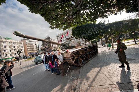 January 19, 2011; a scene of the people gathered with the Tunisian army around tanks on Habib Bourguiba Avenue in Tunis