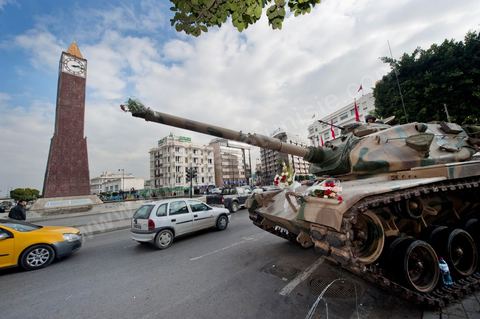January 19, 2011; a scene of the people gathered with the Tunisian army around tanks on Habib Bourguiba Avenue in Tunis