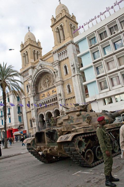 January 19, 2011; a scene of the people gathered with the Tunisian army around tanks on Habib Bourguiba Avenue in Tunis, in front of the cathedral