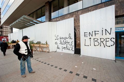 On the city walls, slogans and signs from the People's Revolution protesters are displayed in Arabic and French.