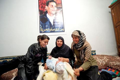 February 9: The mother and her daughters with Salem’s newborn son Omar, Mohamed’s brother, born on December 17, 2010—the day Mohamed Bouazizi set himself on fire. At Mohamed Bouazizi’s home on the 40th day after his death. With his immediate family—his mother, uncle, brother, and sisters—and friends from the neighborhood, they celebrated the 40th day since Mohamed Bouazizi’s death. In Muslim culture, the 40th day is the day when the soul of the deceased leaves the earth to enter paradise, but it is also the day when the parents must accept the departure of their loved one—the day when the period of mourning is declared over. On this day, close relatives gather to eat at the home of the deceased’s family.