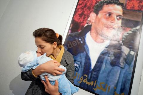February 9: Leila, Mohamed’s sister, with Omar, the newborn son of Salem, Mohamed’s brother, born on December 17, 2010—the day Mohamed Bouazizi set himself on fire. At Mohamed Bouazizi’s home on the 40th day after his death. Together with his immediate family—his mother, uncle, brother, and sisters—and friends from the neighborhood, they celebrated the 40th day since Mohamed Bouazizi’s death. In Muslim culture, the 40th day is the day when the soul of the deceased leaves the earth to enter paradise, but it is also the day when the family must accept the departure of their loved one—the day when the period of mourning is declared over. On this day, close relatives gather to eat at the home of the deceased’s family.