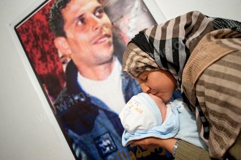 February 9: Mohamed’s sister, with Omar, the newborn son of Salem, Mohamed’s brother, born on December 17, 2010—the day Mohamed Bouazizi set himself on fire. At Mohamed Bouazizi’s home on the 40th day after his death. With his immediate family—his mother, uncle, brother, and sisters—and friends from the neighborhood, they celebrated the 40th day since Mohamed Bouazizi’s death. In Muslim culture, the 40th day is the day when the soul of the deceased leaves the earth to enter paradise, but it is also the day when the family must come to terms with the loss of their loved one—the day when the period of mourning is officially declared over. On this day, close relatives gather for a meal at the home of the deceased’s family.
