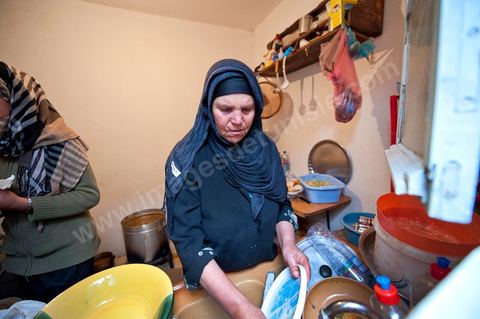 February 9: In the kitchen, Mohamed’s mother and her daughters prepare a meal for the guests at Mohamed Bouazizi’s home on the 40th day after his death. Together with his immediate family—his mother, uncle, brother, and sisters—and friends from the neighborhood, they celebrate the 40th day since Mohamed Bouazizi’s death. In Muslim culture, the 40th day is the day when the soul of the deceased leaves the earth to enter paradise; it is also the day when the family must accept the departure of their loved one—the day when the mourning period is declared over. On this day, close relatives gather to eat at the home of the deceased’s family.