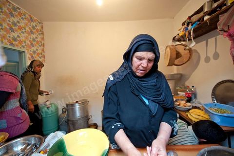 February 9: In the kitchen, Mohamed’s mother and her daughters prepare a meal for the guests at Mohamed Bouazizi’s home on the 40th day after his death. Together with his immediate family—his mother, uncle, brother, and sisters—and friends from the neighborhood, they celebrate the 40th day since Mohamed Bouazizi’s death. In Muslim culture, the 40th day is the day when the soul of the deceased leaves the earth to enter paradise; it is also the day when the family must accept the departure of their loved one—the day when the mourning period is declared over. On this day, close relatives gather to eat at the home of the deceased’s family.