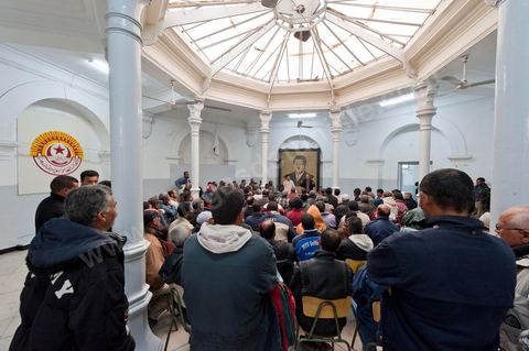 March 12, 2011: In the Rotonde’s main hall, under the watchful eye of Farhat Hached (a giant portrait) at the UGTT headquarters, a meeting of union members from a private construction company, SBF, to establish the SBF shop-floor union and elect union representatives through a vote by UGTT/SBF members. The vote was supervised by the Tunis Regional Office, chaired here by Mr. Amor Bouderbala, a member of the UGGT Tunis Executive Board. Seventeen UGTT/SBF union representatives are running for seven elected positions. At the heart of the UGTT (Tunisian General Labor Union), at its historic headquarters on Mohamed Ali Square in Tunis.