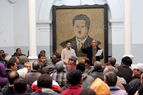 March 12, 2011: In the Rotonde’s main hall, under the watchful eye of Farhat Hached (a giant portrait) at the UGTT headquarters, a meeting of union members from a private construction company, SBF, to establish the SBF shop-floor union and elect union representatives through a vote by UGTT/SBF members. The vote was supervised by the Tunis Regional Office, chaired here by Mr. Amor Bouderbala, a member of the UGGT Tunis Executive Board. Seventeen UGTT/SBF union representatives are running for seven elected positions. At the heart of the UGTT (Tunisian General Labor Union), at its historic headquarters on Mohamed Ali Square in Tunis.