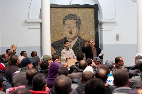 March 12, 2011: In the Rotonde’s main hall, under the watchful eye of Farhat Hached (a giant portrait) at the UGTT headquarters, a meeting of union members from a private construction company, SBF, to establish the SBF shop-floor union and elect union representatives through a vote by UGTT/SBF members. The vote was supervised by the Tunis Regional Office, chaired here by Mr. Amor Bouderbala, a member of the UGGT Tunis Executive Board. Seventeen UGTT/SBF union representatives are running for seven elected positions. At the heart of the UGTT (Tunisian General Labor Union), at its historic headquarters on Mohamed Ali Square in Tunis.