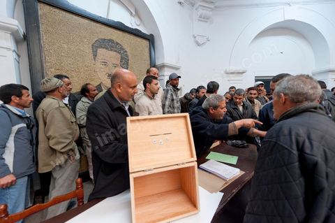 March 12, 2011: In the Rotonde’s main hall, under the watchful eye of Farhat Hached (a giant portrait) at the UGTT headquarters, a meeting of union members from a private construction company, SBF, to establish the SBF shop-floor union and elect union representatives through a vote by UGTT/SBF members. The vote was supervised by the Tunis Regional Office, chaired here by Mr. Amor Bouderbala, a member of the UGGT Tunis Executive Board. Seventeen UGTT/SBF union representatives are running for seven elected positions. At the heart of the UGTT (Tunisian General Labor Union), at its historic headquarters on Mohamed Ali Square in Tunis.