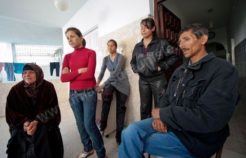 The Bouazizi Family’s New Home

Forced to leave Sidi Bouzid, where the pressure had become too much for them, the Bouazizi family found refuge 260 kilometers away, in Tunis. Mohamed Bouazizi’s mother, the iconic figure of Tunisia’s popular uprising, his sisters, and his two youngest brothers live in a house with blue ceramic tiles—a three-room ground-floor apartment—in the working-class neighborhood of Bousalsa in La Marsa, on the northern outskirts of Tunis. Leila, the 24-year-old eldest sister, is enrolled in a work-study vocational program to become a quality control inspector in the textile industry;  Semia, 19, is preparing for her high school diploma, while Basma, 16, Karim, 14, and Zyed, 8, are still in school. Only the eldest brother, Salem, lives elsewhere, in Sfax. Singled out by some residents of Sidi Bouzid, who accuse her of receiving money from the government, the Bouazizi family produces the lease for their new home, which they plan to rent for six months, through August, at a cost of 360 dinars (180 euros). Soon, the mother promises, they will return to Sidi Bouzid.