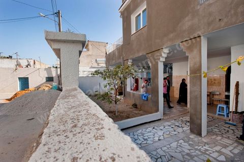 The Bouazizi Family’s New Home

Forced to leave Sidi Bouzid, where the pressure had become too much for them, the Bouazizi family found refuge 260 kilometers away, in Tunis. Mohamed Bouazizi’s mother, the iconic figure of Tunisia’s popular uprising, his sisters, and his two youngest brothers live in a house with blue ceramic tiles—a three-room ground-floor apartment—in the working-class neighborhood of Bousalsa in La Marsa, on the northern outskirts of Tunis. Leila, the 24-year-old eldest sister, is enrolled in a work-study vocational program to become a quality control inspector in the textile industry;  Semia, 19, is preparing for her high school diploma, while Basma, 16, Karim, 14, and Zyed, 8, are still in school. Only the eldest brother, Salem, lives elsewhere, in Sfax. Singled out by some residents of Sidi Bouzid, who accuse her of receiving money from the government, the Bouazizi family produces the lease for their new home, which they plan to rent for six months, through August, at a cost of 360 dinars (180 euros). Soon, the mother promises, they will return to Sidi Bouzid.