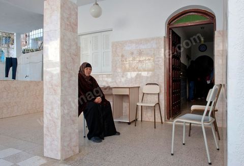 The Bouazizi Family’s New Home

Forced to leave Sidi Bouzid, where the pressure had become too much for them, the Bouazizi family found refuge 260 kilometers away, in Tunis. Mohamed Bouazizi’s mother, the iconic figure of Tunisia’s popular uprising, his sisters, and his two youngest brothers live in a house with blue ceramic tiles—a three-room ground-floor apartment—in the working-class neighborhood of Bousalsa in La Marsa, on the northern outskirts of Tunis. Leila, the 24-year-old eldest sister, is enrolled in a work-study vocational program to become a quality control inspector in the textile industry;  Semia, 19, is preparing for her high school diploma, while Basma, 16, Karim, 14, and Zyed, 8, are still in school. Only the eldest brother, Salem, lives elsewhere, in Sfax. Singled out by some residents of Sidi Bouzid, who accuse her of receiving money from the government, the Bouazizi family produces the lease for their new home, which they plan to rent for six months, through August, at a cost of 360 dinars (180 euros). Soon, the mother promises, they will return to Sidi Bouzid.