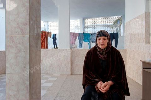 The Bouazizi Family’s New Home

Forced to leave Sidi Bouzid, where the pressure had become too much for them, the Bouazizi family found refuge 260 kilometers away, in Tunis. Mohamed Bouazizi’s mother, the iconic figure of Tunisia’s popular uprising, his sisters, and his two youngest brothers live in a house with blue ceramic tiles—a three-room ground-floor apartment—in the working-class neighborhood of Bousalsa in La Marsa, on the northern outskirts of Tunis. Leila, the 24-year-old eldest sister, is enrolled in a work-study vocational program to become a quality control inspector in the textile industry;  Semia, 19, is preparing for her high school diploma, while Basma, 16, Karim, 14, and Zyed, 8, are still in school. Only the eldest brother, Salem, lives elsewhere, in Sfax. Singled out by some residents of Sidi Bouzid, who accuse her of receiving money from the government, the Bouazizi family produces the lease for their new home, which they plan to rent for six months, through August, at a cost of 360 dinars (180 euros). Soon, the mother promises, they will return to Sidi Bouzid.