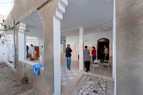 The Bouazizi Family’s New Home

Forced to leave Sidi Bouzid, where the pressure had become too much for them, the Bouazizi family found refuge 260 kilometers away, in Tunis. Mohamed Bouazizi’s mother, the iconic figure of Tunisia’s popular uprising, his sisters, and his two youngest brothers live in a house with blue ceramic tiles—a three-room ground-floor apartment—in the working-class neighborhood of Bousalsa in La Marsa, on the northern outskirts of Tunis. Leila, the 24-year-old eldest sister, is enrolled in a work-study vocational program to become a quality control inspector in the textile industry;  Semia, 19, is preparing for her high school diploma, while Basma, 16, Karim, 14, and Zyed, 8, are still in school. Only the eldest brother, Salem, lives elsewhere, in Sfax. Singled out by some residents of Sidi Bouzid, who accuse her of receiving money from the government, the Bouazizi family produces the lease for their new home, which they plan to rent for six months, through August, at a cost of 360 dinars (180 euros). Soon, the mother promises, they will return to Sidi Bouzid.