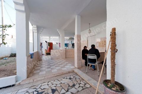 The Bouazizi Family’s New Home

Forced to leave Sidi Bouzid, where the pressure had become too much for them, the Bouazizi family found refuge 260 kilometers away, in Tunis. Mohamed Bouazizi’s mother, the iconic figure of Tunisia’s popular uprising, his sisters, and his two youngest brothers live in a house with blue ceramic tiles—a three-room ground-floor apartment—in the working-class neighborhood of Bousalsa in La Marsa, on the northern outskirts of Tunis. Leila, the 24-year-old eldest sister, is enrolled in a work-study vocational program to become a quality control inspector in the textile industry;  Semia, 19, is preparing for her high school diploma, while Basma, 16, Karim, 14, and Zyed, 8, are still in school. Only the eldest brother, Salem, lives elsewhere, in Sfax. Singled out by some residents of Sidi Bouzid, who accuse her of receiving money from the government, the Bouazizi family produces the lease for their new home, which they plan to rent for six months, through August, at a cost of 360 dinars (180 euros). Soon, the mother promises, they will return to Sidi Bouzid.