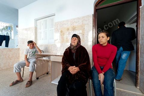 The Bouazizi Family’s New Home

Forced to leave Sidi Bouzid, where the pressure had become too much for them, the Bouazizi family found refuge 260 kilometers away, in Tunis. Mohamed Bouazizi’s mother, the iconic figure of Tunisia’s popular uprising, his sisters, and his two youngest brothers live in a house with blue ceramic tiles—a three-room ground-floor apartment—in the working-class neighborhood of Bousalsa in La Marsa, on the northern outskirts of Tunis. Leila, the 24-year-old eldest sister, is enrolled in a work-study vocational program to become a quality control inspector in the textile industry;  Semia, 19, is preparing for her high school diploma, while Basma, 16, Karim, 14, and Zyed, 8, are still in school. Only the eldest brother, Salem, lives elsewhere, in Sfax. Singled out by some residents of Sidi Bouzid, who accuse her of receiving money from the government, the Bouazizi family produces the lease for their new home, which they plan to rent for six months, through August, at a cost of 360 dinars (180 euros). Soon, the mother promises, they will return to Sidi Bouzid.