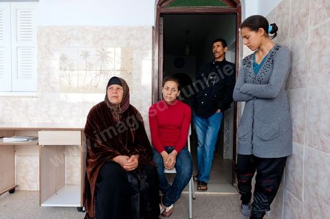 The Bouazizi Family’s New Home

Forced to leave Sidi Bouzid, where the pressure had become too much for them, the Bouazizi family found refuge 260 kilometers away, in Tunis. Mohamed Bouazizi’s mother, the iconic figure of Tunisia’s popular uprising, his sisters, and his two youngest brothers live in a house with blue ceramic tiles—a three-room ground-floor apartment—in the working-class neighborhood of Bousalsa in La Marsa, on the northern outskirts of Tunis. Leila, the 24-year-old eldest sister, is enrolled in a work-study vocational program to become a quality control inspector in the textile industry;  Semia, 19, is preparing for her high school diploma, while Basma, 16, Karim, 14, and Zyed, 8, are still in school. Only the eldest brother, Salem, lives elsewhere, in Sfax. Singled out by some residents of Sidi Bouzid, who accuse her of receiving money from the government, the Bouazizi family produces the lease for their new home, which they plan to rent for six months, through August, at a cost of 360 dinars (180 euros). Soon, the mother promises, they will return to Sidi Bouzid.