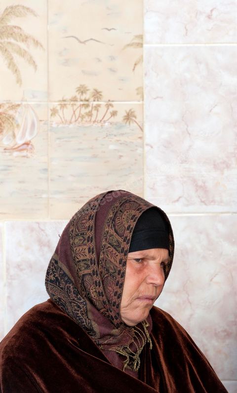 The Bouazizi Family’s New Home

Forced to leave Sidi Bouzid, where the pressure had become too much for them, the Bouazizi family found refuge 260 kilometers away, in Tunis. Mohamed Bouazizi’s mother, the iconic figure of Tunisia’s popular uprising, his sisters, and his two youngest brothers live in a house with blue ceramic tiles—a three-room ground-floor apartment—in the working-class neighborhood of Bousalsa in La Marsa, on the northern outskirts of Tunis. Leila, the 24-year-old eldest sister, is enrolled in a work-study vocational program to become a quality control inspector in the textile industry;  Semia, 19, is preparing for her high school diploma, while Basma, 16, Karim, 14, and Zyed, 8, are still in school. Only the eldest brother, Salem, lives elsewhere, in Sfax. Singled out by some residents of Sidi Bouzid, who accuse her of receiving money from the government, the Bouazizi family produces the lease for their new home, which they plan to rent for six months, through August, at a cost of 360 dinars (180 euros). Soon, the mother promises, they will return to Sidi Bouzid.