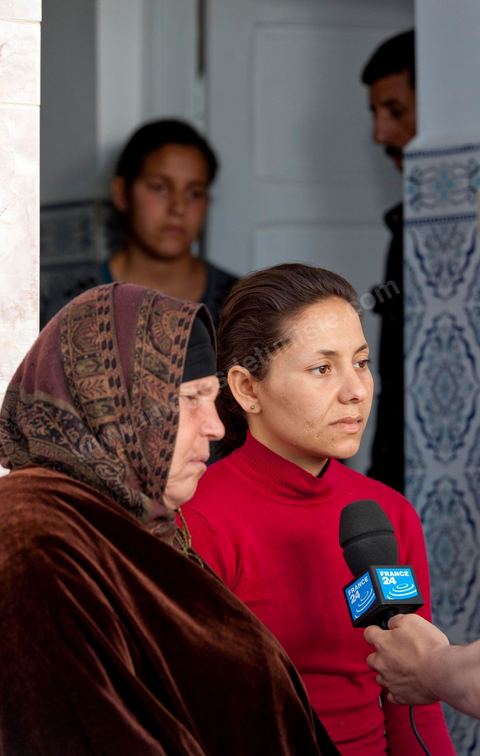 The Bouazizi Family’s New Home

Forced to leave Sidi Bouzid, where the pressure had become too much for them, the Bouazizi family found refuge 260 kilometers away, in Tunis. Mohamed Bouazizi’s mother, the iconic figure of Tunisia’s popular uprising, his sisters, and his two youngest brothers live in a house with blue ceramic tiles—a three-room ground-floor apartment—in the working-class neighborhood of Bousalsa in La Marsa, on the northern outskirts of Tunis. Leila, the 24-year-old eldest sister, is enrolled in a work-study vocational program to become a quality control inspector in the textile industry;  Semia, 19, is preparing for her high school diploma, while Basma, 16, Karim, 14, and Zyed, 8, are still in school. Only the eldest brother, Salem, lives elsewhere, in Sfax. Singled out by some residents of Sidi Bouzid, who accuse her of receiving money from the government, the Bouazizi family produces the lease for their new home, which they plan to rent for six months, through August, at a cost of 360 dinars (180 euros). Soon, the mother promises, they will return to Sidi Bouzid.