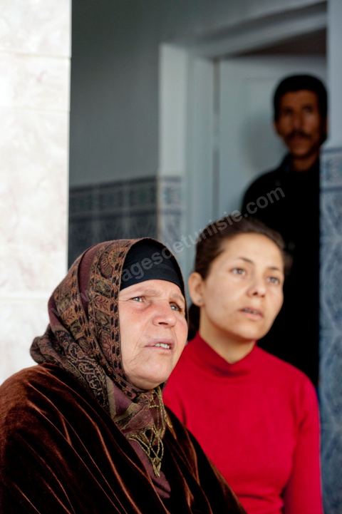 The Bouazizi Family’s New Home

Forced to leave Sidi Bouzid, where the pressure had become too much for them, the Bouazizi family found refuge 260 kilometers away, in Tunis. Mohamed Bouazizi’s mother, the iconic figure of Tunisia’s popular uprising, his sisters, and his two youngest brothers live in a house with blue ceramic tiles—a three-room ground-floor apartment—in the working-class neighborhood of Bousalsa in La Marsa, on the northern outskirts of Tunis. Leila, the 24-year-old eldest sister, is enrolled in a work-study vocational program to become a quality control inspector in the textile industry;  Semia, 19, is preparing for her high school diploma, while Basma, 16, Karim, 14, and Zyed, 8, are still in school. Only the eldest brother, Salem, lives elsewhere, in Sfax. Singled out by some residents of Sidi Bouzid, who accuse her of receiving money from the government, the Bouazizi family produces the lease for their new home, which they plan to rent for six months, through August, at a cost of 360 dinars (180 euros). Soon, the mother promises, they will return to Sidi Bouzid.