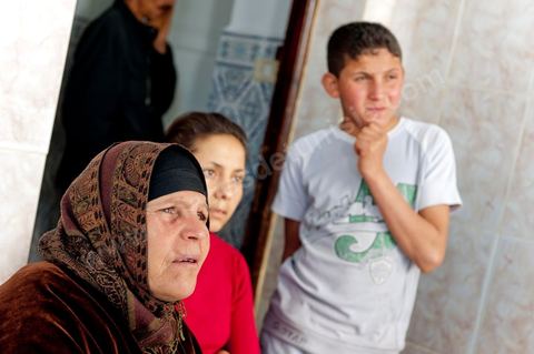 The Bouazizi Family’s New Home

Forced to leave Sidi Bouzid, where the pressure had become too much for them, the Bouazizi family found refuge 260 kilometers away, in Tunis. Mohamed Bouazizi’s mother, the iconic figure of Tunisia’s popular uprising, his sisters, and his two youngest brothers live in a house with blue ceramic tiles—a three-room ground-floor apartment—in the working-class neighborhood of Bousalsa in La Marsa, on the northern outskirts of Tunis. Leila, the 24-year-old eldest sister, is enrolled in a work-study vocational program to become a quality control inspector in the textile industry;  Semia, 19, is preparing for her high school diploma, while Basma, 16, Karim, 14, and Zyed, 8, are still in school. Only the eldest brother, Salem, lives elsewhere, in Sfax. Singled out by some residents of Sidi Bouzid, who accuse her of receiving money from the government, the Bouazizi family produces the lease for their new home, which they plan to rent for six months, through August, at a cost of 360 dinars (180 euros). Soon, the mother promises, they will return to Sidi Bouzid.