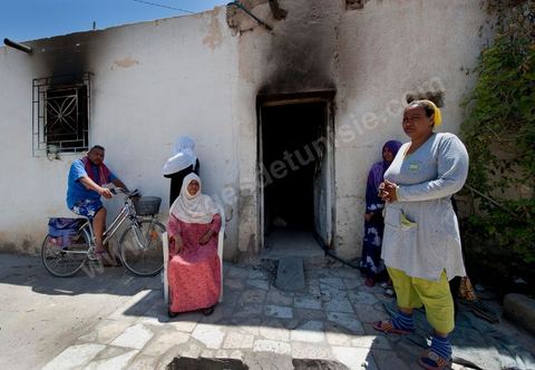 Women from the Jeridian tribe in front of their burned-down home in the Tripolitain neighborhood during the clashes of June 3–5, 2011, in the city of Metlaoui
