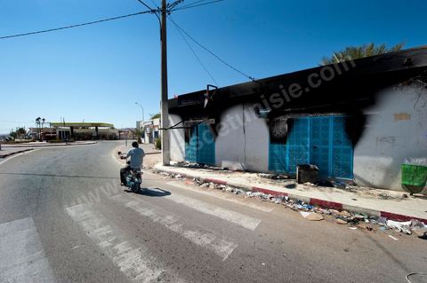 A store set on fire on the main street in the neighborhood during the clashes of June 3–5, 2011, in the city of Metlaoui