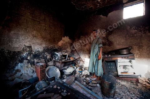 A young person amid the rubble of the family home that was burned down in the working-class neighborhood of Tripolitains during the clashes of June 3–5, 2011, in the city of Metlaoui