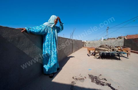 A mother mourns the death of her daughter, who was shot and killed on the porch of their home following the clashes that took place from June 3 to 5, 2011, in the town of Metlaoui