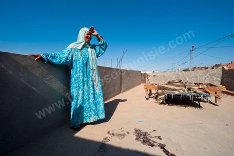 A mother mourns the death of her daughter, who was shot and killed on the porch of their home following the clashes that took place from June 3 to 5, 2011, in the town of Metlaoui