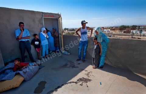 A mother mourns the death of her daughter, who was shot and killed on the porch of their home following the clashes that took place from June 3 to 5, 2011, in the town of Metlaoui