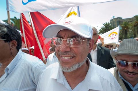 15 août 2011 : Hamadi JEBALI, n°2 du parti à tendance islamique Ennahda et ses gardes du corps à la manif de l'UGGT. L'Union Générale Tunisienne du Travail a organisé une marche de protestation ''pour la réalisation des objectifs de la révolution et en mémoire des martyrs'' qui a débuté lundi 15 août 2011 à midi devant la bourse du travail à Tunis avant de parcourir l'avenue Mohamed V et de se disperser devant la place des droits de l'Homme.Ont participé à cette marche, les structures régionales et locales de base de l'Union, des partis politiques, des personnalités nationales, des composantes de la société civile, des intellectuels et des artistes.Les manifestants ont exprimé des revendications à caractère social et politique exigeant notamment le départ du Gouvernement de transition et de demander des comptes aux symboles de la corruption, notamment par une restitution des avoirs du peuple, spoliés par la famille du président déchu, la réforme de la Justice et l'emploi aux chômeurs.Les manifestants ont dénoncé la hausse des prix et appelé au respect des principes de la révolution et à la fidélité au sang des martyrs.La marche a été marquée par un arrêt symbolique devant le siège de l'ancien Rassemblement Constitutionnel Démocratique dissous."La Tunisie libre et les voleurs dehors", "Peuple, révolte-toi contre les restants de la dictature", "Pas de liberté, pas de retour, pour les bandes du destour" ont scandé les manifestants.