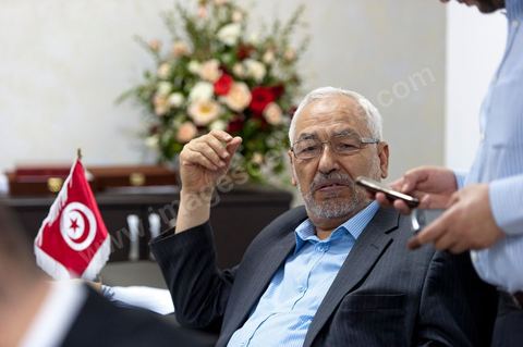 In his office, Rached Ghannouchi waits to watch the election results announced on TV during the election night coverage at the Ennahda party headquarters in Tunis. 
