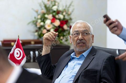 In his office, Rached Ghannouchi waits to watch the election results announced on TV during the election night coverage at the Ennahda party headquarters in Tunis. 