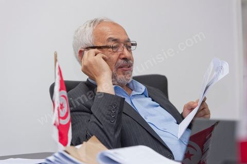 In his office, Rached Ghannouchi waits to watch the election results announced on TV during the election night coverage at the Ennahda party headquarters in Tunis. 