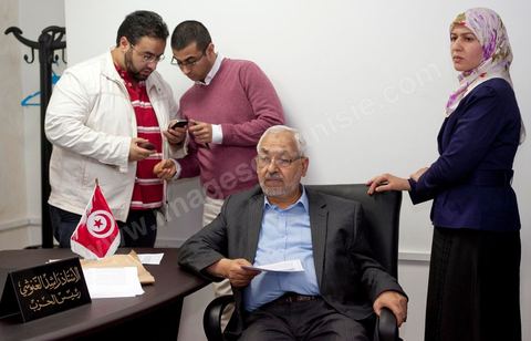 In his office, Rached Ghannouchi, president and founder of Ennahda, waits with his daughter Yosr and his son (on the left), Bara, for the results during the election night event at Ennahda’s party headquarters in Tunis. 