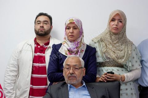 In his office, Rached Ghannouchi, his daughter Intissar (on the right), his daughter Yosr (in the middle), and his son Bara watch the election results being announced on TV during the election night coverage at the Ennahda party headquarters in Tunis. 