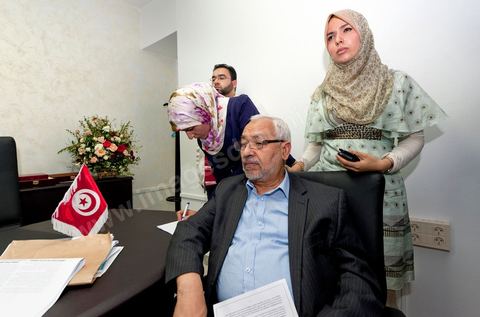 In his office, Rached Ghannouchi, his daughter Intissar (on the right), his daughter Yosr (in the middle), and his son Bara watch the election results being announced on TV during the election night coverage at the Ennahda party headquarters in Tunis. 