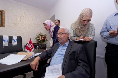 In the office of Rached Ghannouchi, president and founder of Ennahda, he and his daughters Intissar (right), Yosr (left), and his son Bara are reviewing the preliminary results during the election night event at Ennahda’s party headquarters in Tunis. 