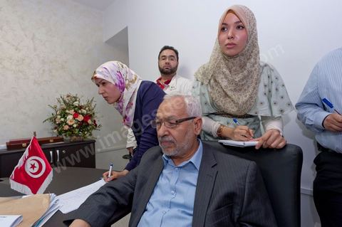In the office of Rached Ghannouchi, president and founder of Ennahda, he and his daughters Intissar (right), Yosr (left), and his son Bara are reviewing the preliminary results during the election night event at Ennahda’s party headquarters in Tunis. 