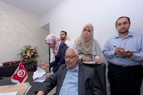 In the office of Rached Ghannouchi, president and founder of Ennahda, he and his daughters Intissar (right), Yosr (left), and Bara (back left), along with his son, watch the preliminary results during the election night event at Ennahda’s party headquarters in Tunis. 