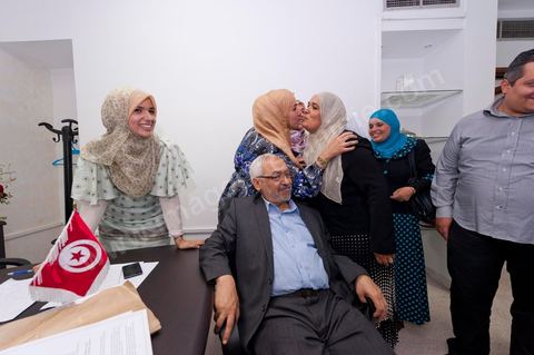 In the office of Rached Ghannouchi, president and founder of Ennahda, he poses with his daughters Soumaya (center), Intissar (left), and Yosr (right) congratulate one another upon the announcement of the preliminary results during the election night event at the Ennahda party headquarters in Tunis. 