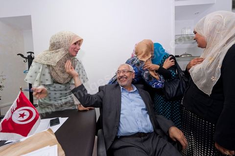 In the office of Rached Ghannouchi, president and founder of Ennahda, he poses with his daughters Soumaya (center), Intissar (left), and Yosr (right) congratulate one another upon the announcement of the preliminary results during the election night event at the Ennahda party headquarters in Tunis. 