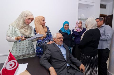 In the office of Rached Ghannouchi, president and founder of Ennahda, he poses with his daughters Soumaya (center), Intissar (left), and Yosr (right) congratulate one another upon the announcement of the preliminary results during the election night event at the Ennahda party headquarters in Tunis. 