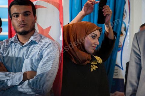 Soumaya Ghannouchi, Rached's daughter, watches the press conference in front of the Ennahda party headquarters; the crowd begins to gather as soon as the official announcement of the preliminary results declares Ennahda the winner.