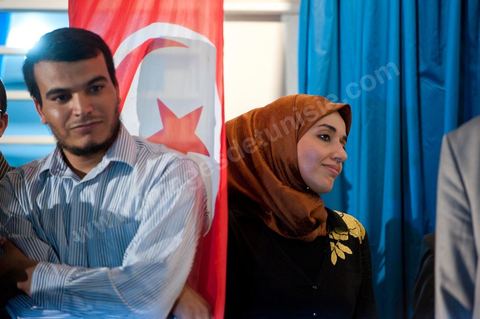 Soumaya Ghannouchi, Rached's daughter, watches the press conference in front of the Ennahda party headquarters; the crowd begins to gather as soon as the official announcement of the preliminary results declares Ennahda the winner.