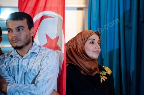 Soumaya Ghannouchi, Rached's daughter, watches the press conference in front of the Ennahda party headquarters; the crowd begins to gather as soon as the official announcement of the preliminary results declares Ennahda the winner.